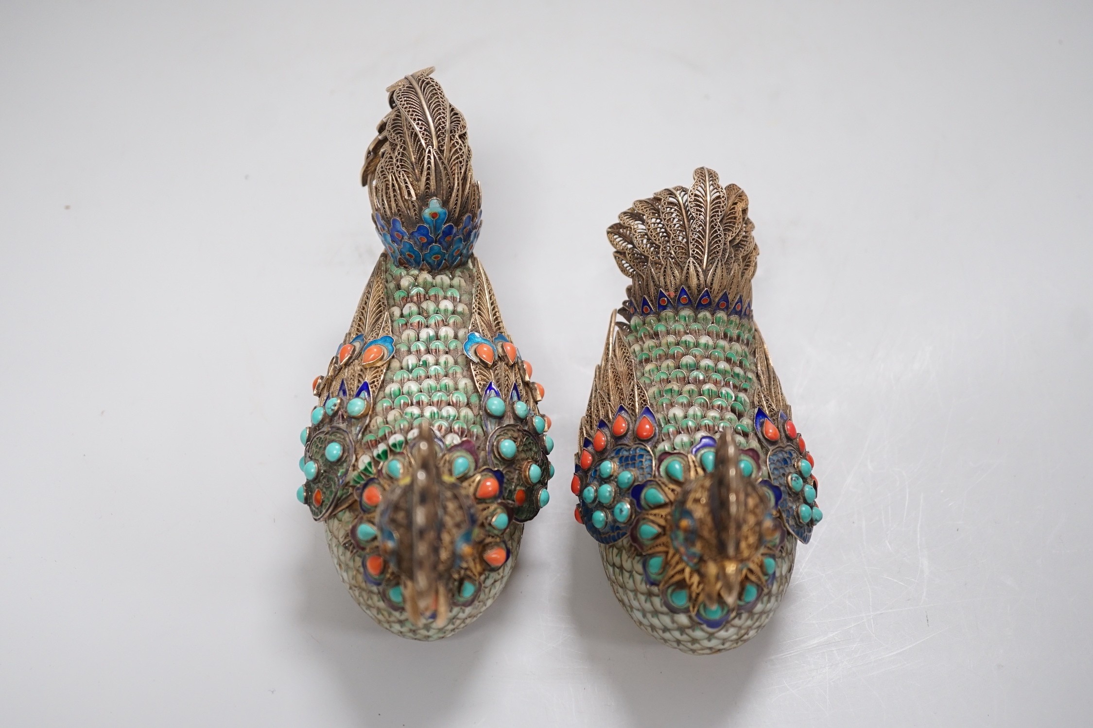 A pair of cased Chinese enamelled gilt white metal roosters with turquoise and coral mounts 14cms wide